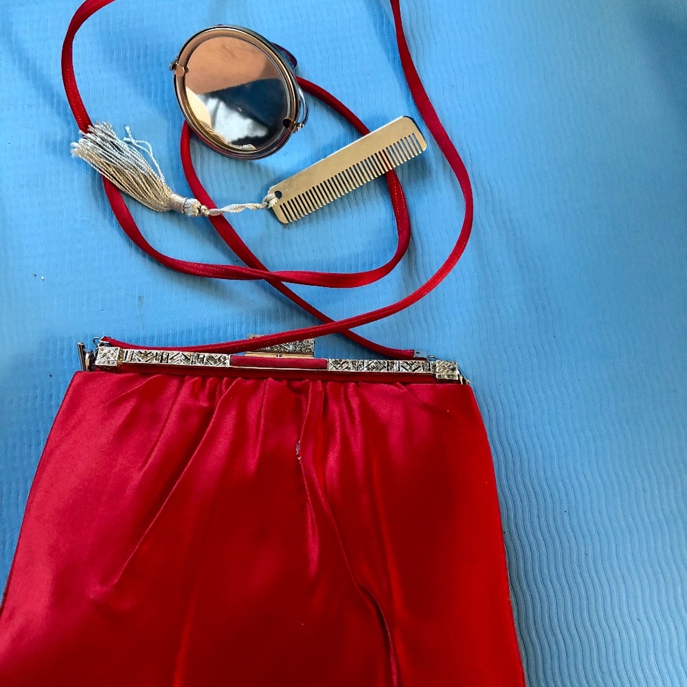 Evening bag, red satin. Strap, comb and mirror.